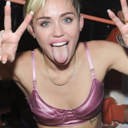 Miley Cyrus pink bra and skirt at album release